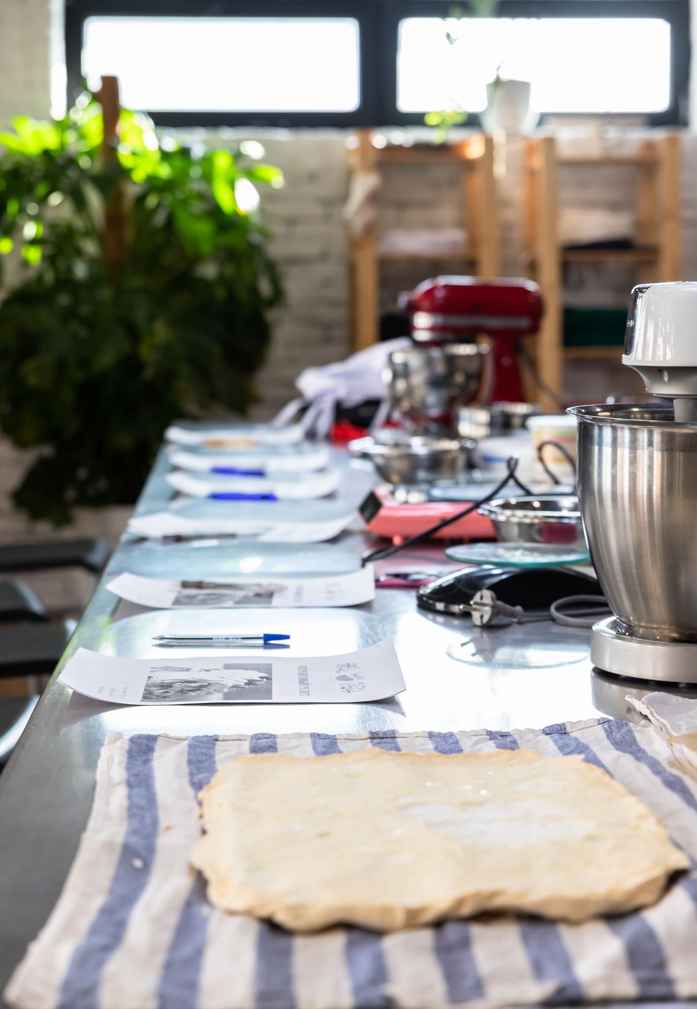 Large editorial photo of workshop table with plated courses